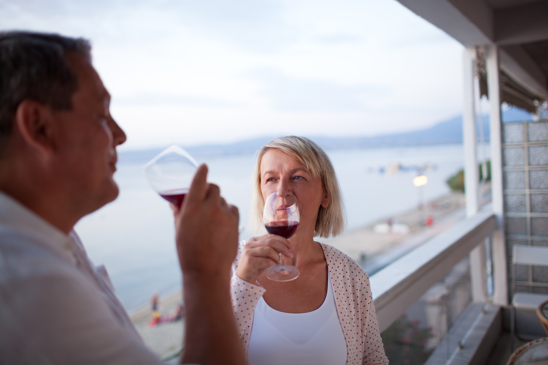 Couple drinking red wine on the balcony of their hotel on South Hutchinson Island