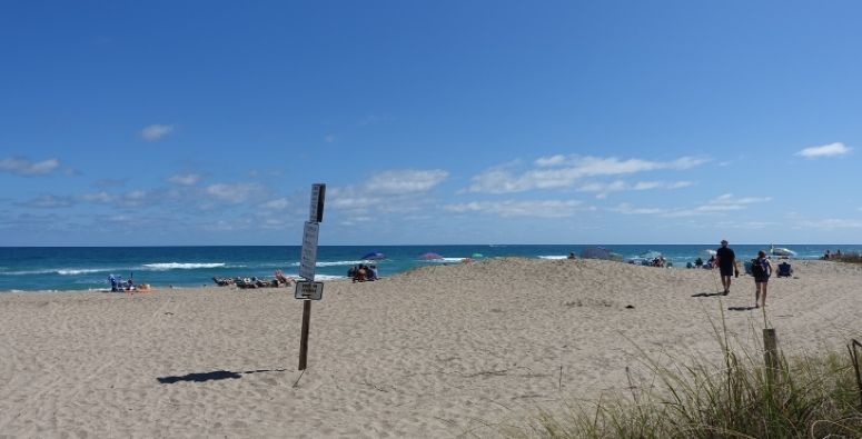 South Hutchinson Island beach with people lounging in the sand or walking around